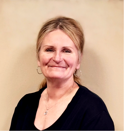 Smiling blonde woman in black top against neutral background professional portrait