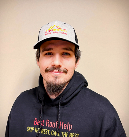 Smiling man wearing a logo cap and branded sweatshirt in a portrait