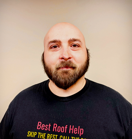 Portrait of a bearded man wearing a black shirt with bold lettering