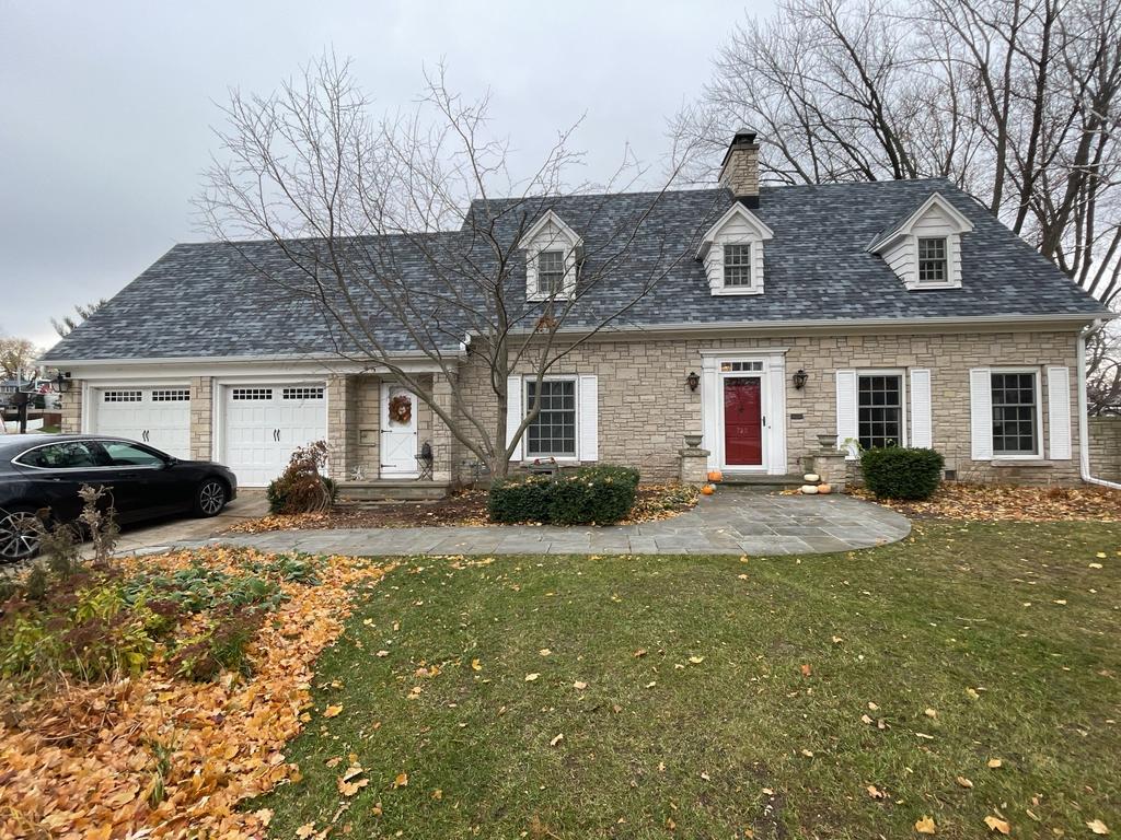 Charming stone house with red door and dormer windows