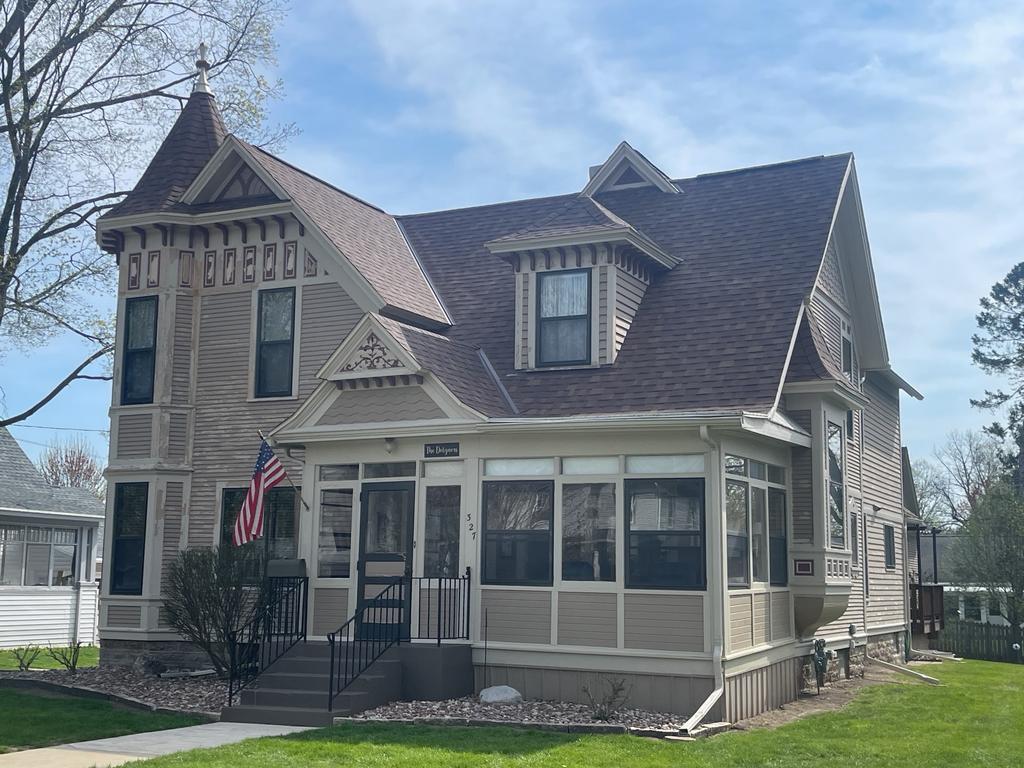 Victorian-style house with American flag and ornate details