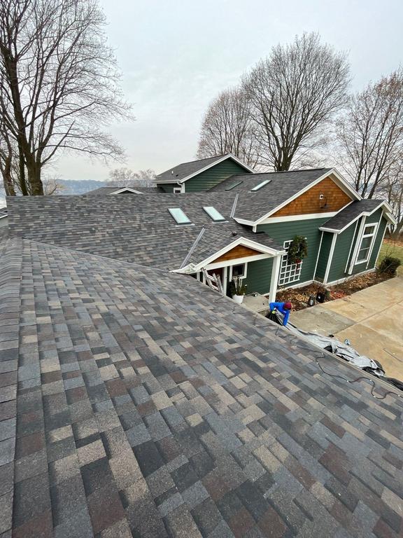 Residential home with new asphalt shingle roofing and attached garage